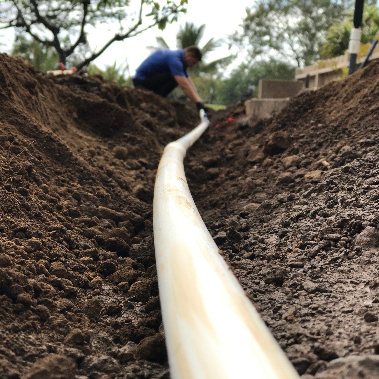 Professional installation of an irrigation system on Hawaii. Sprinkler and drip systems use pvc pipe like the one shown in the image to connect water lines.