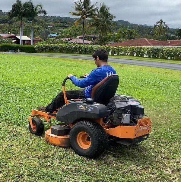 zero turn mower being used to perform mowing services on a large acreage on the island of Hawaii.