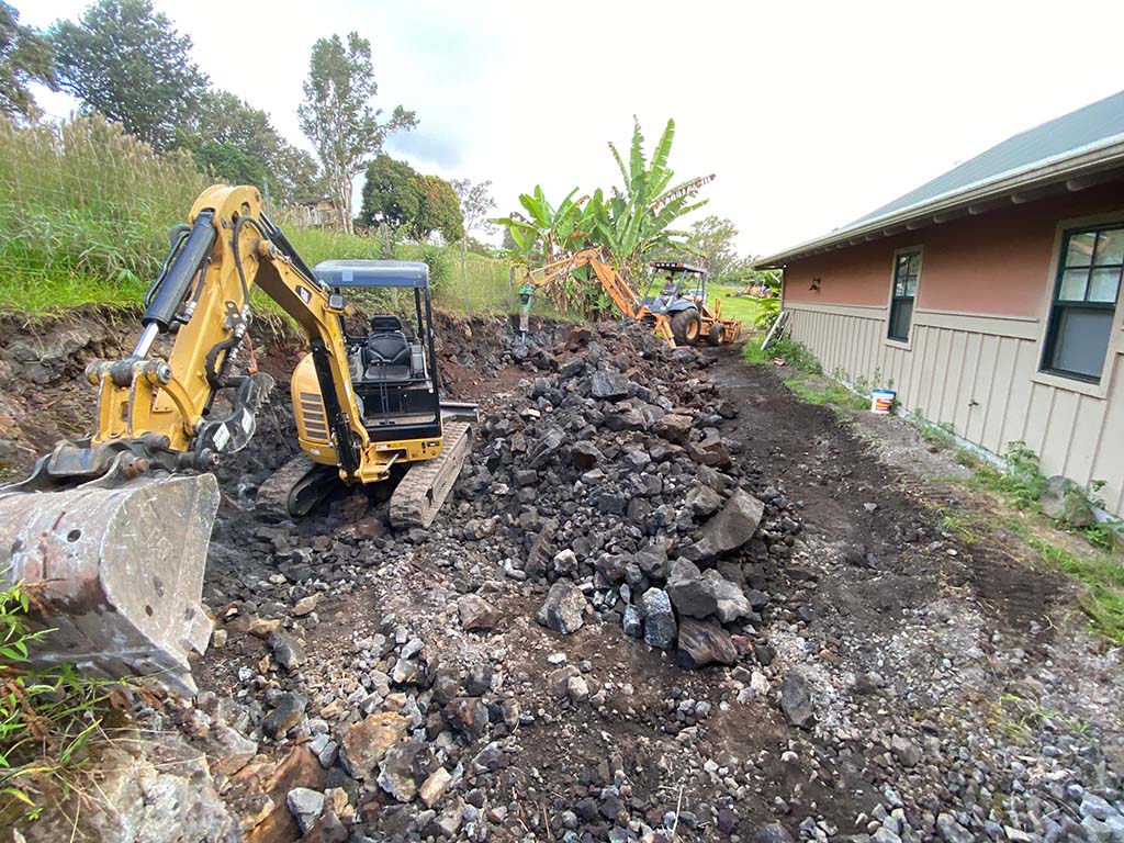 Kona trenching and rock removal services being performed by local big island landscapers as part of an installation for landscaping, Hawaii.