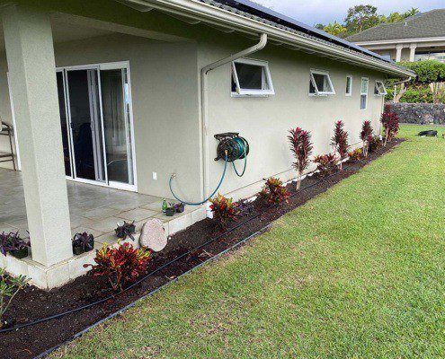 Kailua-Kona flowerbed installation. Hawaii landscaping services installed vinyl edging, shrubs, and aggregate.