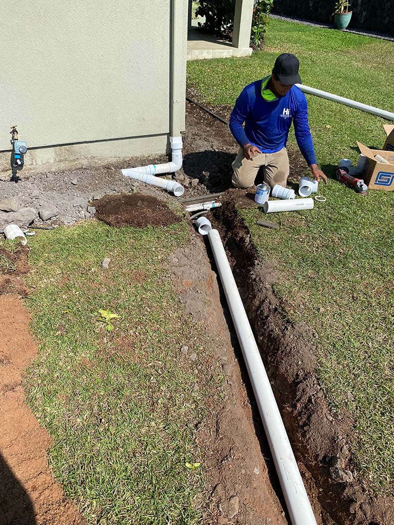 Kona landscapers install irrigation pipe, big island, Hawaii. Landscaping services include pipe, sprinklers, trenching, and turf.