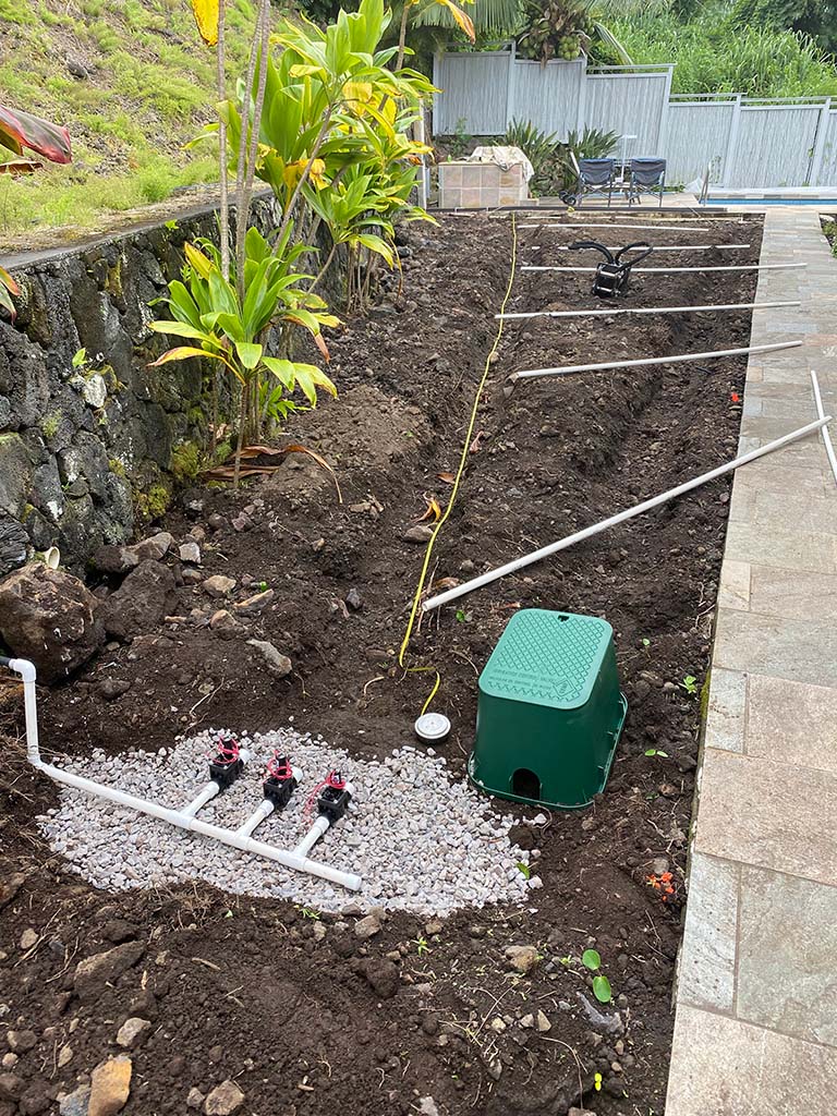 Hawaii sprinkler installation. Big island landscapers install control valves for a sprinkler system as part of a Kona landscape service.