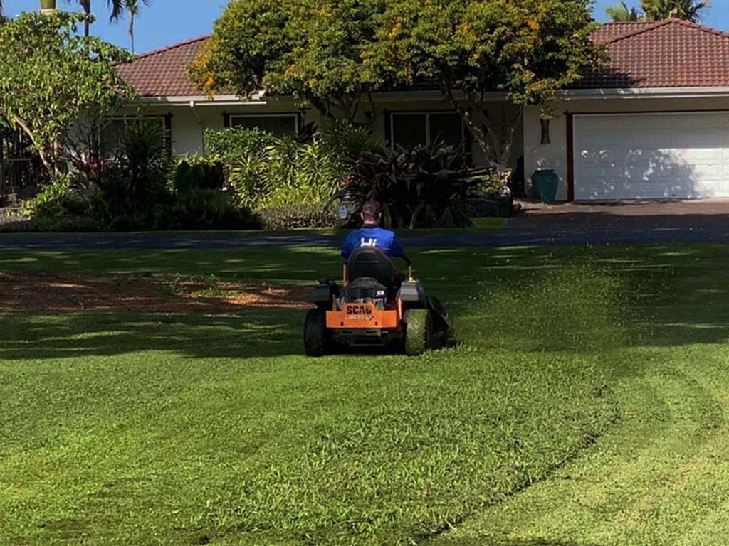 Great Kailua-Kona lawns start with excellent maintenance provide by one of the top big island landscape companies. Zero turn lawnmower being used to mow this large acreage on Hawaii's big island. Professional landscapers, Hawaii.