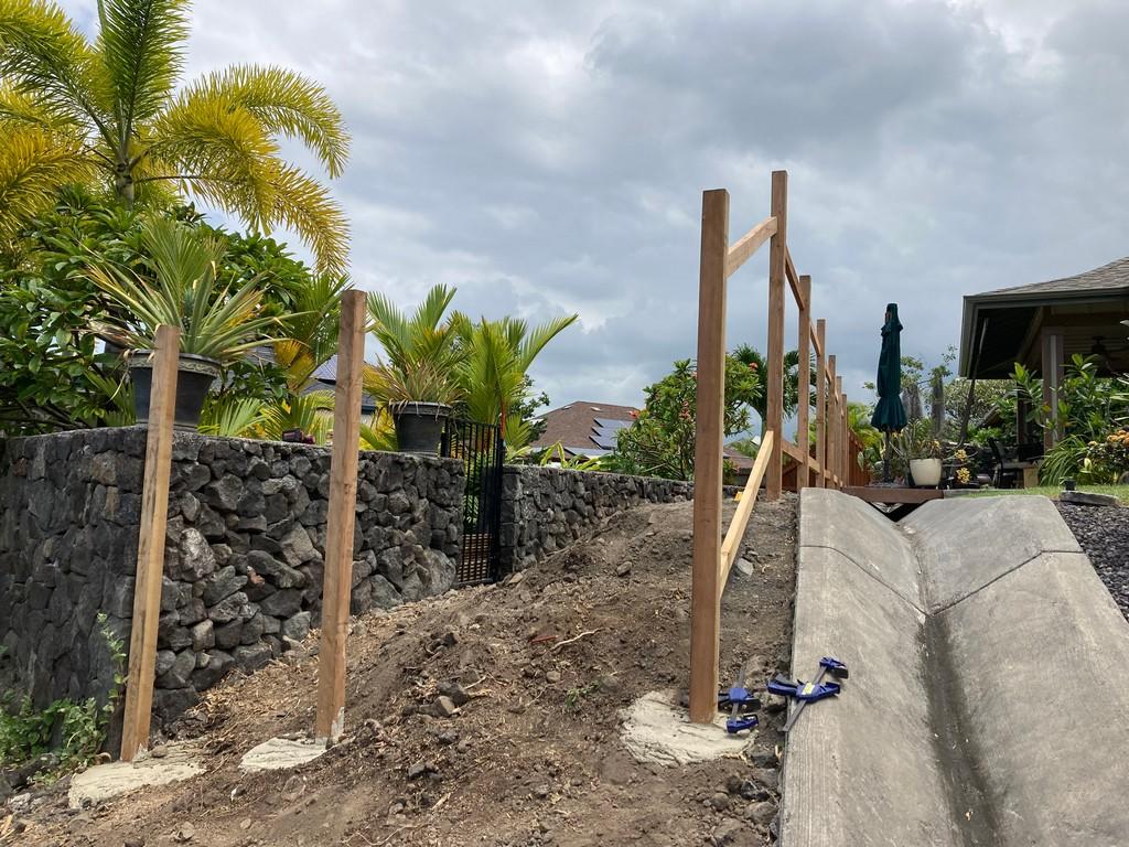 Kailua-Kona fence installation by Hawaii Landscaping. Fence posts are being installed and anchored.