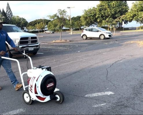 Lowe's parking lot in Kailua-Kona. Parking lot cleaning in Hawaii with a commercial blower. Image by Hawaii Landscaping Company.
