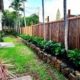 Fence, plant, and custom flowerbed installation.