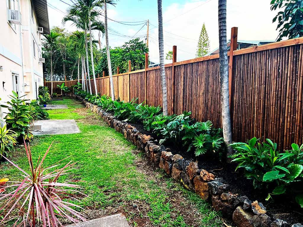 Fence, plant, and custom flowerbed installation.