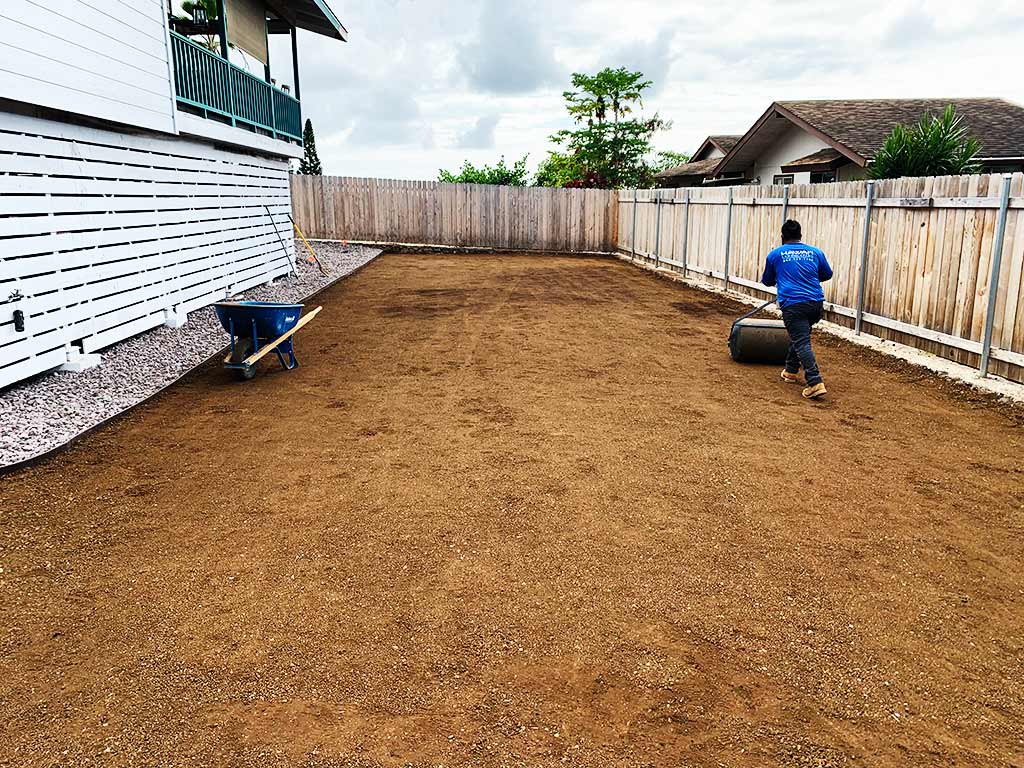 Lawn roller being used by Hawaii landscapers to flatten and smooth topsoil.