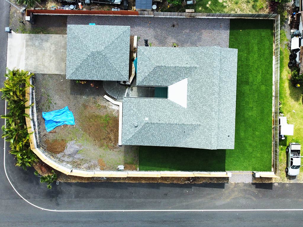Hawaii landscape services take an aerial photo after completing a backyard project.