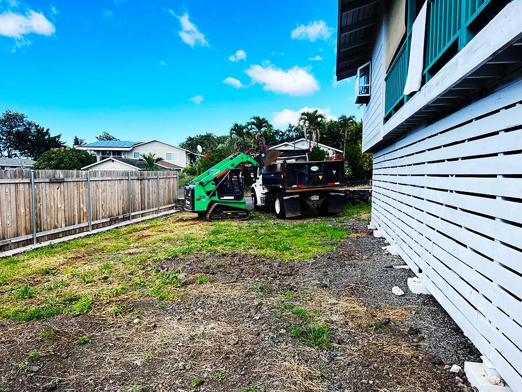 Landscape excavation equipment is being operated by landscapers, Hawaii.
