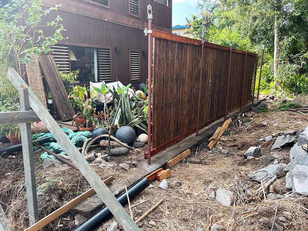 The original bamboo fence around the backyard is in disrepair prior to the fence replacement, Kailua-Kona.