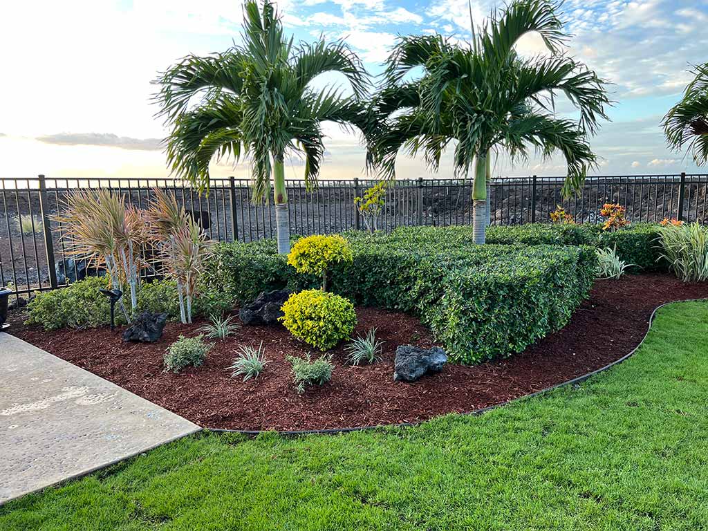Mulch is added to a flowerbed to retain moisture.