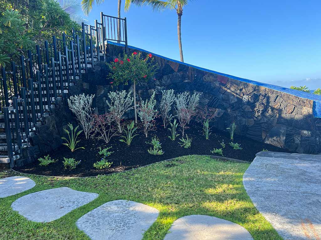 Completed lava rock pool slide, with a custom planter.